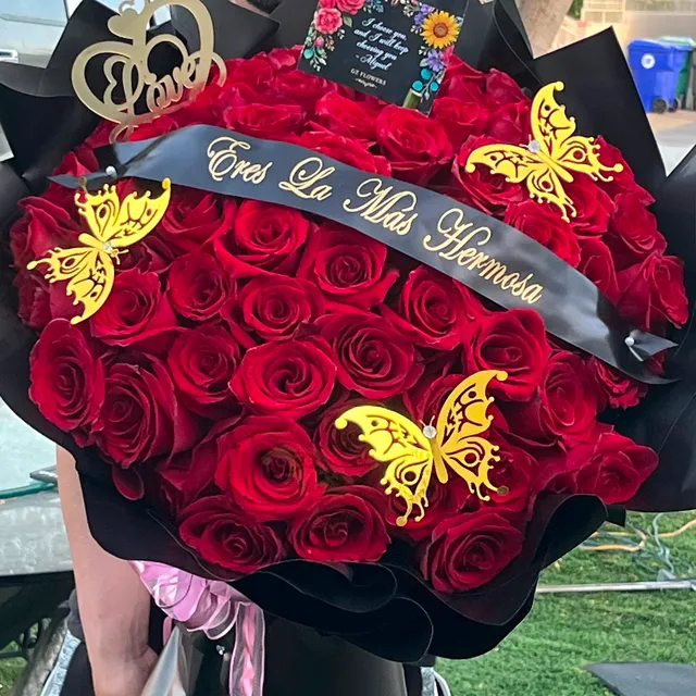 Custom red rose bouquet with a printed satin sash and gold butterflies by GZ Flowers, Cathedral City CA